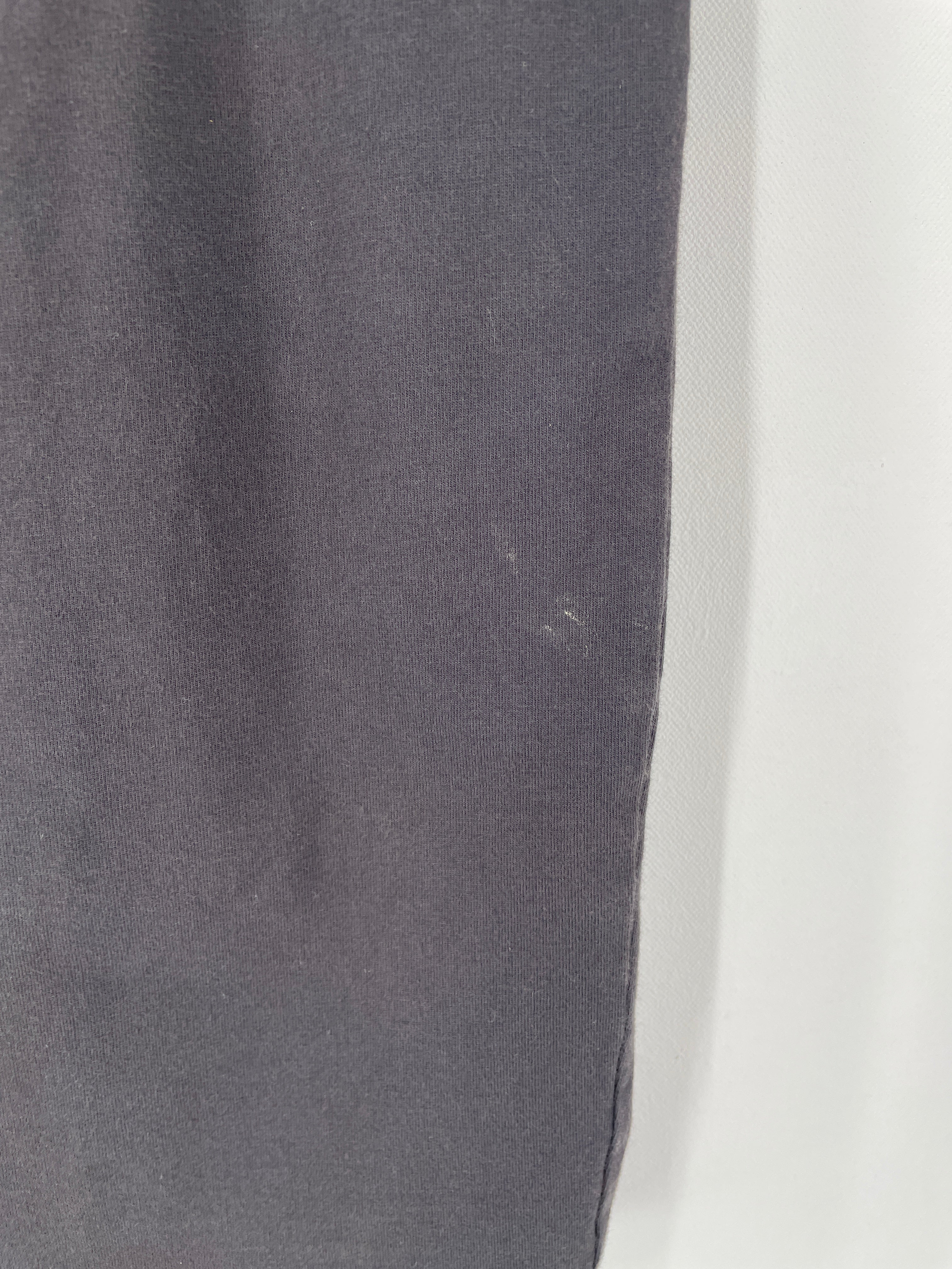 Nahaufnahme von zwei Stoffen: Links ein dunkelgrauer Jersey, rechts weißer Webstoff. Beschreibt den Damen Bleistiftrock Jersey Ruß Gr. S mit Schlitz hinten, gutem Zustand, Fleck vorne.