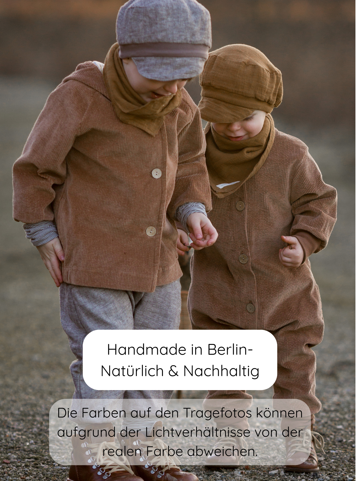 Zwei Kleinkinder tragen die Wichteljacke Breitcord Stretch - Weizen, eine handgemachte, nachhaltige Cordjacke mit Ringel-Armbündchen und Wichtelkapuze, gefertigt in Berlin. Text: „Handmade in Berlin – Natürlich & Nachhaltig“.