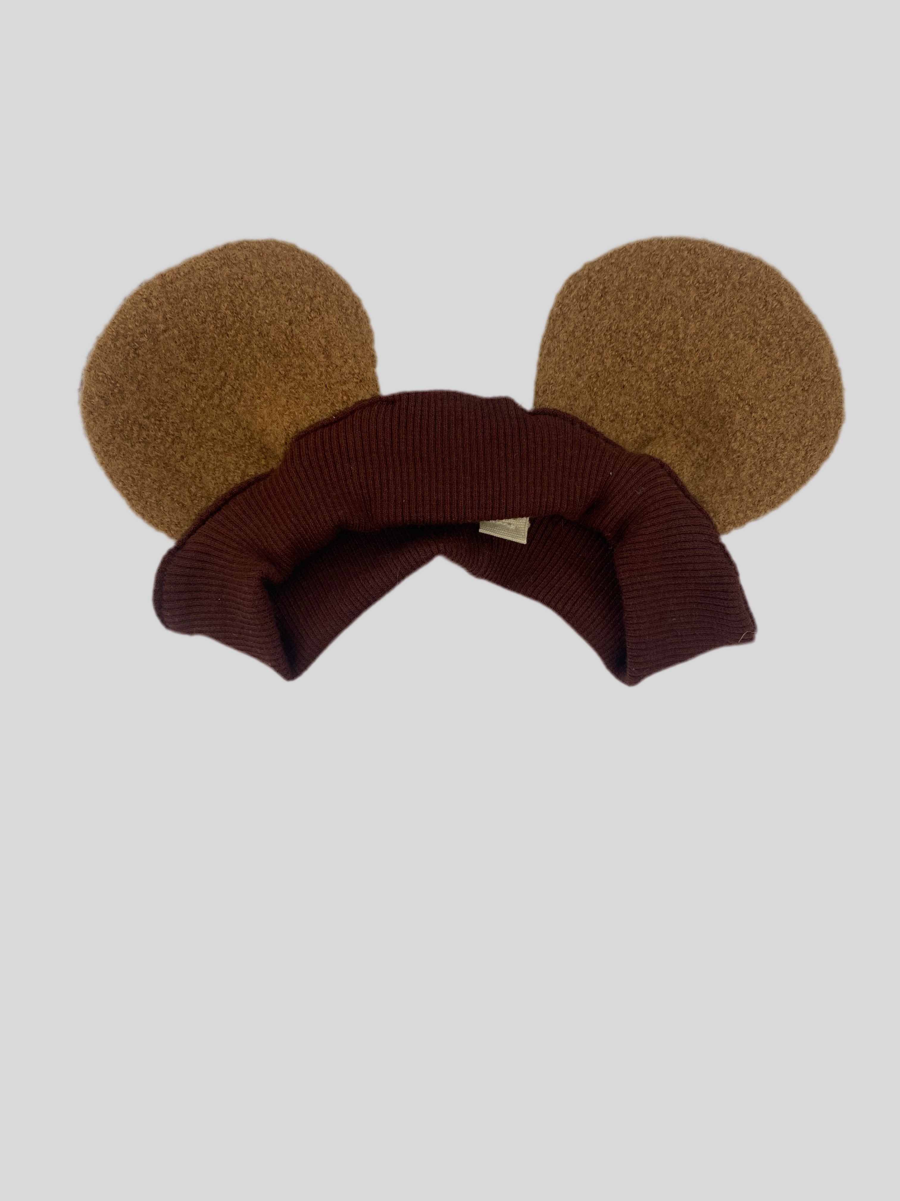Verkleidungs Haarband mit Ohren Schoko Sahara: ein gestricktes Stirnband mit charakteristischen Ohren, das durch seine weiche Textur besticht und vielseitige Tragemöglichkeiten bietet. Zustand: neu.