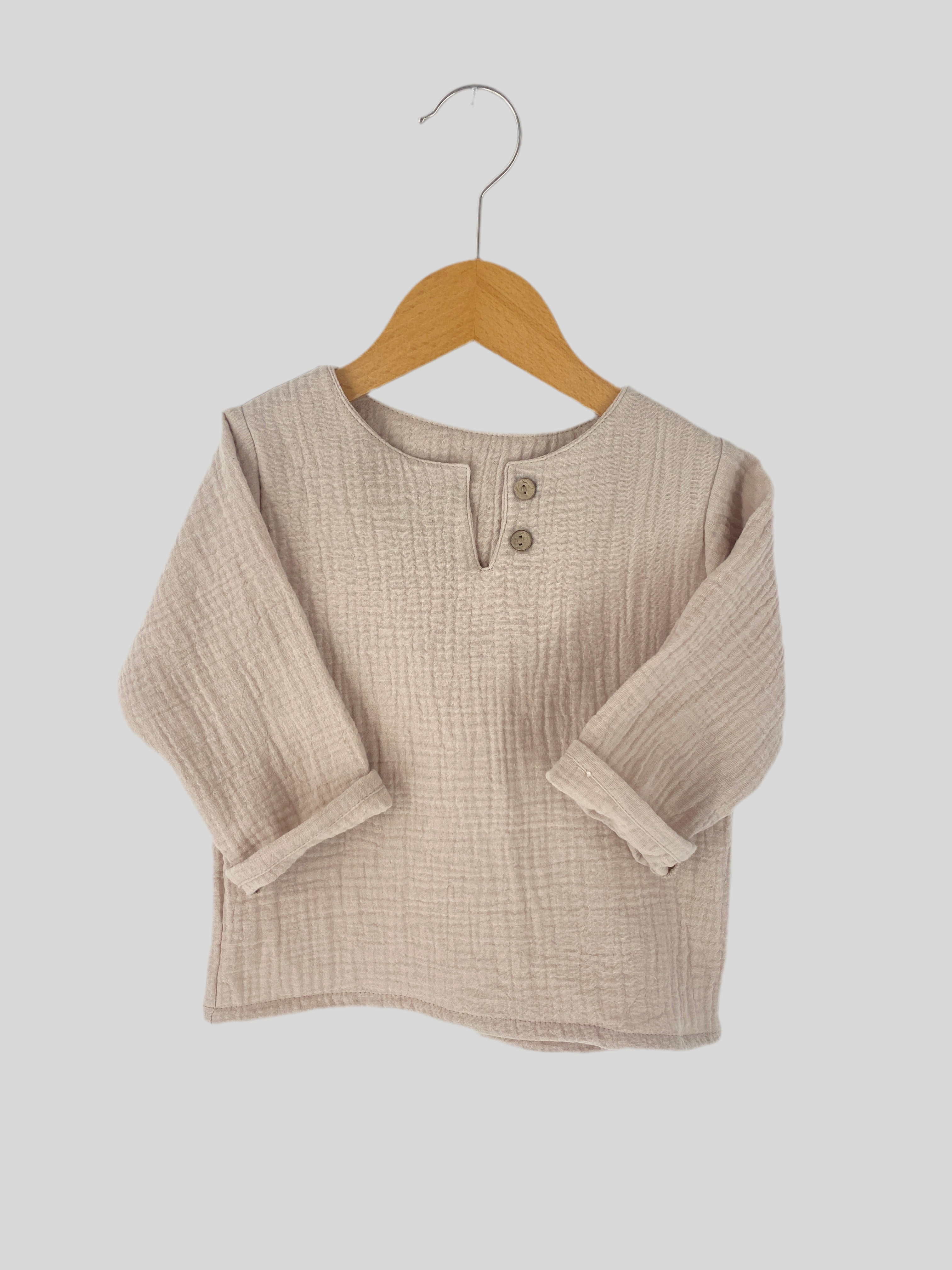 Hemdchen Musselin Sand Gr. 1Y, neu, zeigt feine Musselin-Struktur und dezentes Design, ideal für Kleinkinder. Perfekt für komfortable Alltagskleidung, betont durch weichen Stoff und schlichte Eleganz.