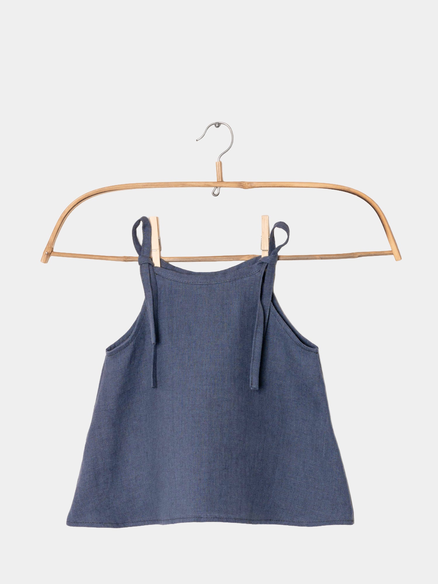 Hängerchen Leinen - Blaubeere: Ein ärmelloses A-Linien-Kleidungsstück aus weichem Leinen mit verstellbaren Bindebändern, das an den Schultern hängt. Ideal als wandelbares Kleid oder Top für Kinder.