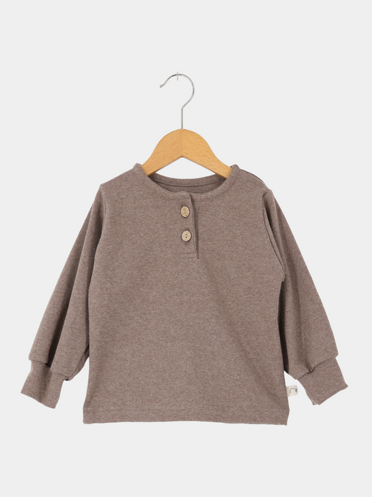 Hemdchen Feinstrick - Praline: Ein einfaches, langärmeliges Henley-Shirt mit Rundhalsausschnitt und Zweiknopfleiste, gefertigt aus feinem Strickstoff. Ideal für den Alltag, bequem und anschmiegsam.