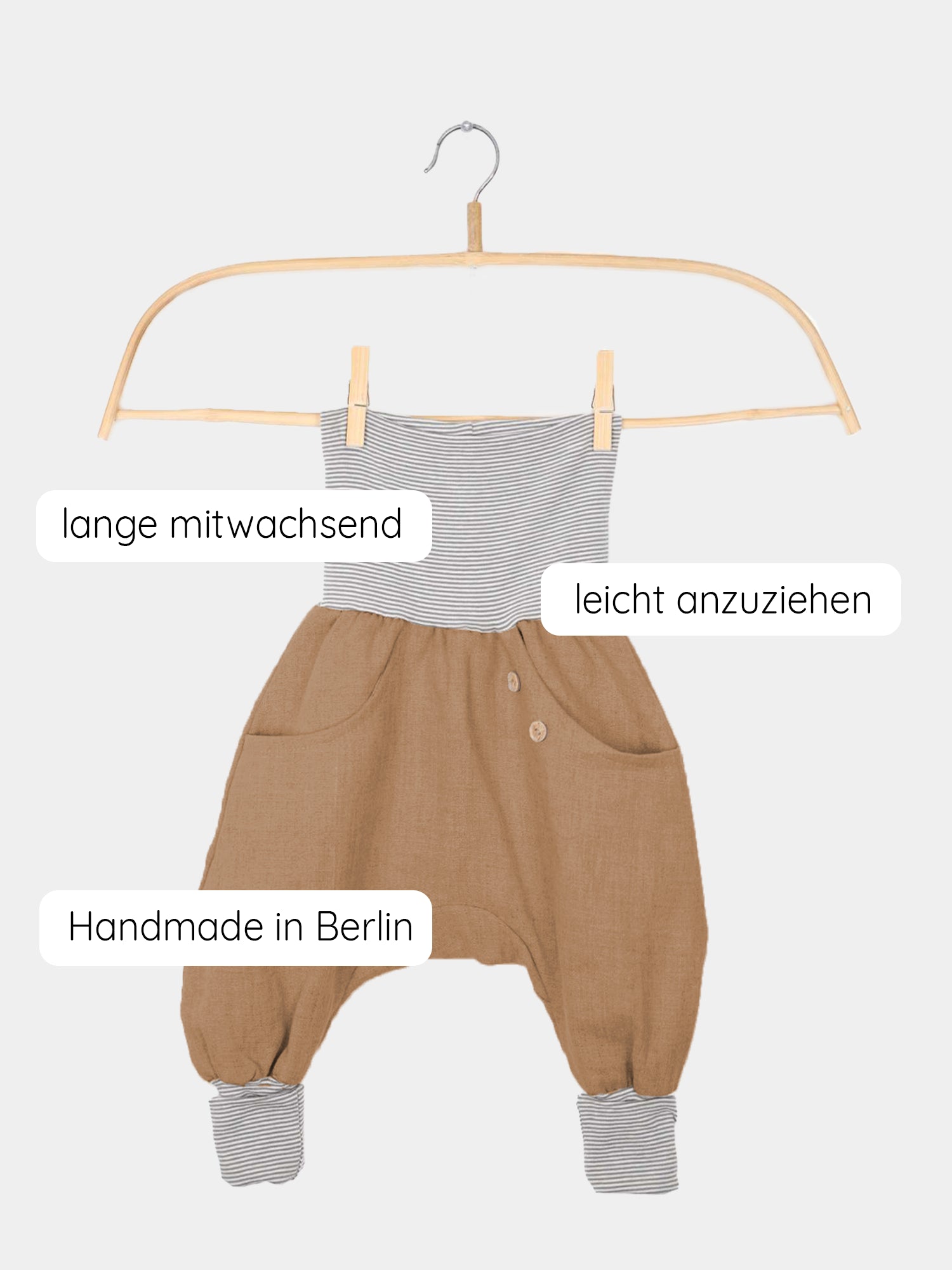 Knickerbocker Leinen - Weizen: Ein haremartiger Kinderstrampler mit grau-weiß gestreiftem Oberteil, weitem braunem Leinen-Look-Unterteil, Fronttaschen, Holzknöpfen und umschlagbaren Bündchen. Handgemacht in Berlin, langlebig und bequem.