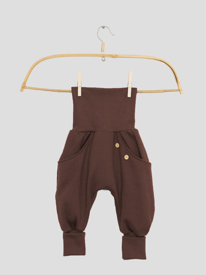 Nahaufnahme der Knickerbocker Bio-Sweat - Schoko mit durchgehender Kängurutasche, klassischen PETIT COCHON Schnitt und Krempelbündchen, die Bewegungsfreiheit bieten. Kombiniert perfekt mit Schlüttli Bio-Sweat.