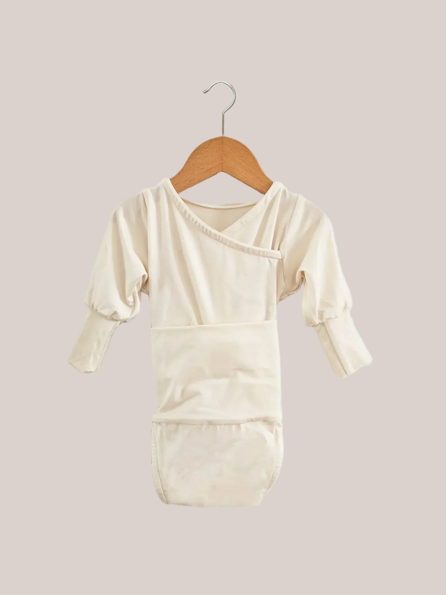 Loopbody Bambusviskose - Natur: Kimono-Stil, langen Ärmeln, eingebautem Bauchband, Wickelverschluss ohne Knöpfe. Hängt an einem Holzkleiderbügel, designed für Komfort und Mitwachsen des Babys.