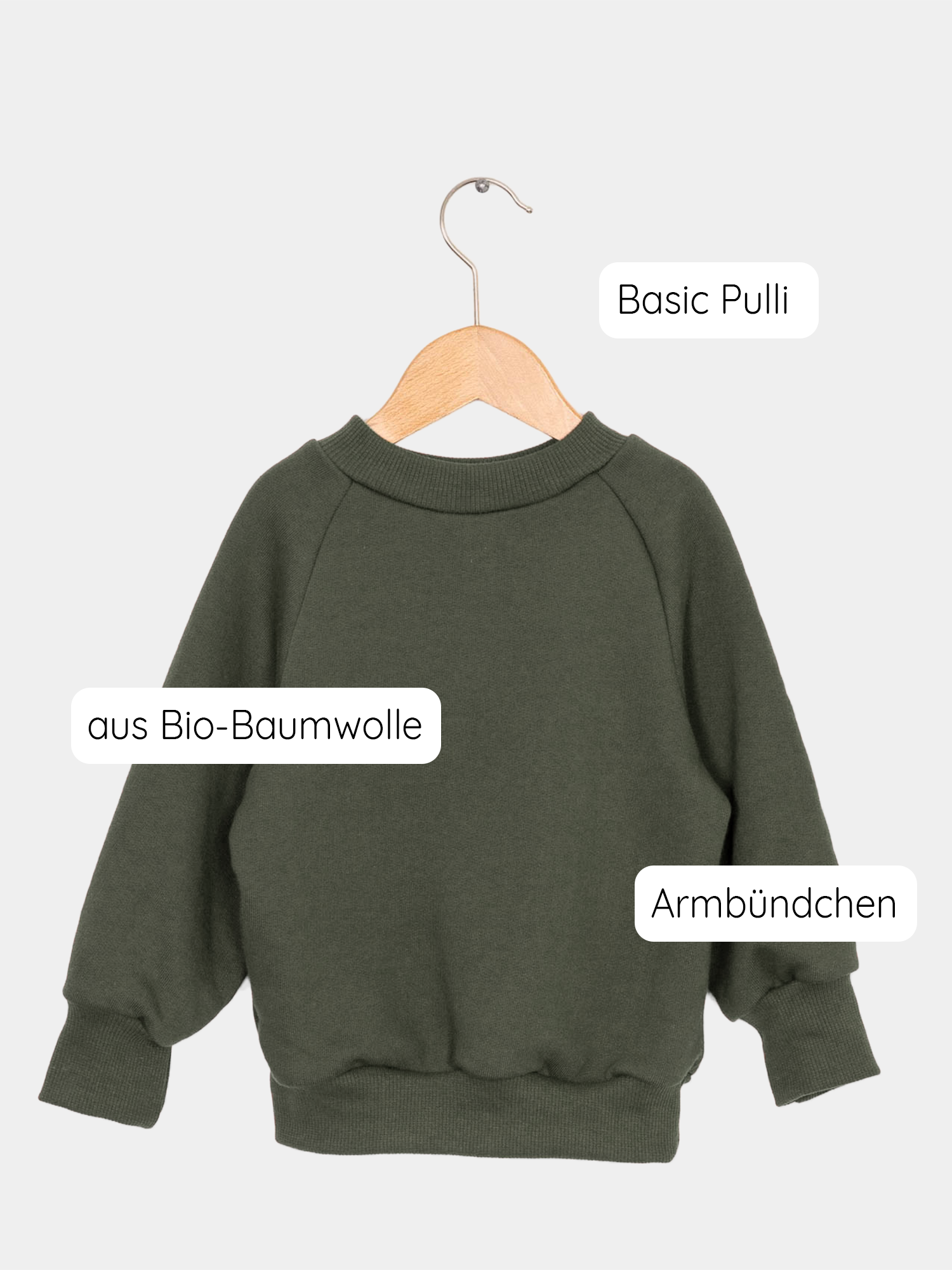 Pulli Bio-Sweat - Avocado: Ein grüner Pullover aus kuschelig weichem, GOTS-zertifiziertem Bio-Sweatstoff, hängt auf einem Schaukelstuhl. Perfekt für Kinder, wächst 2-3 Jahre mit.