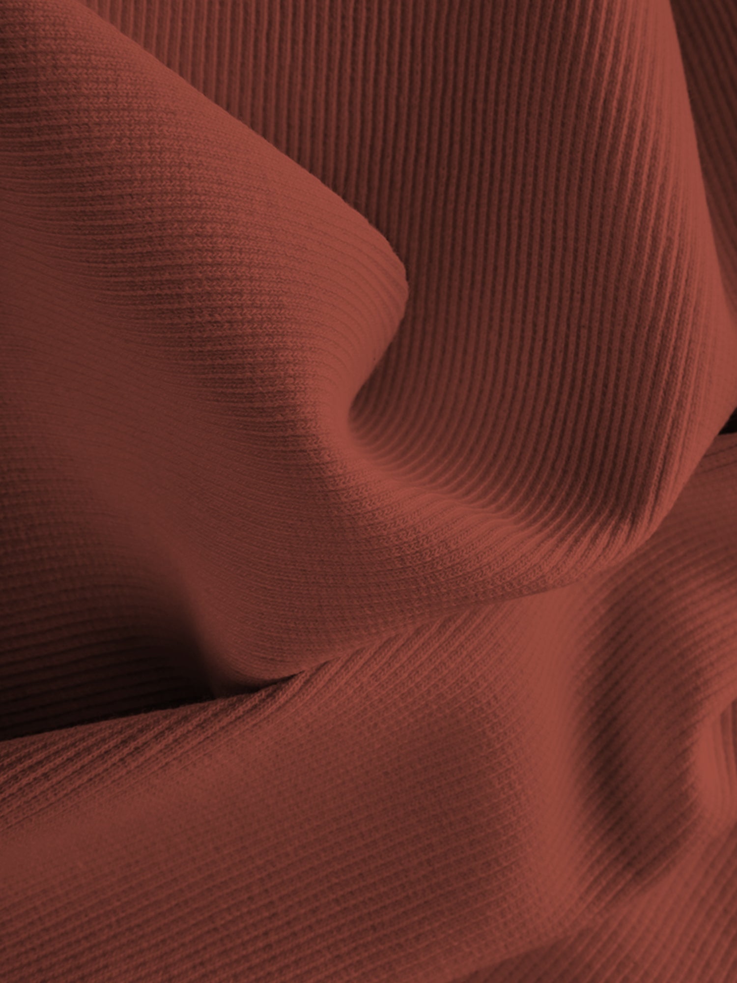Nahaufnahme von Bio-Bündchen Terracotta aus kbA-Baumwolle mit Elasthan, Bio-Rip-Struktur, GOTS-zertifiziert, zeigt die Textur und Qualität des Stoffes.