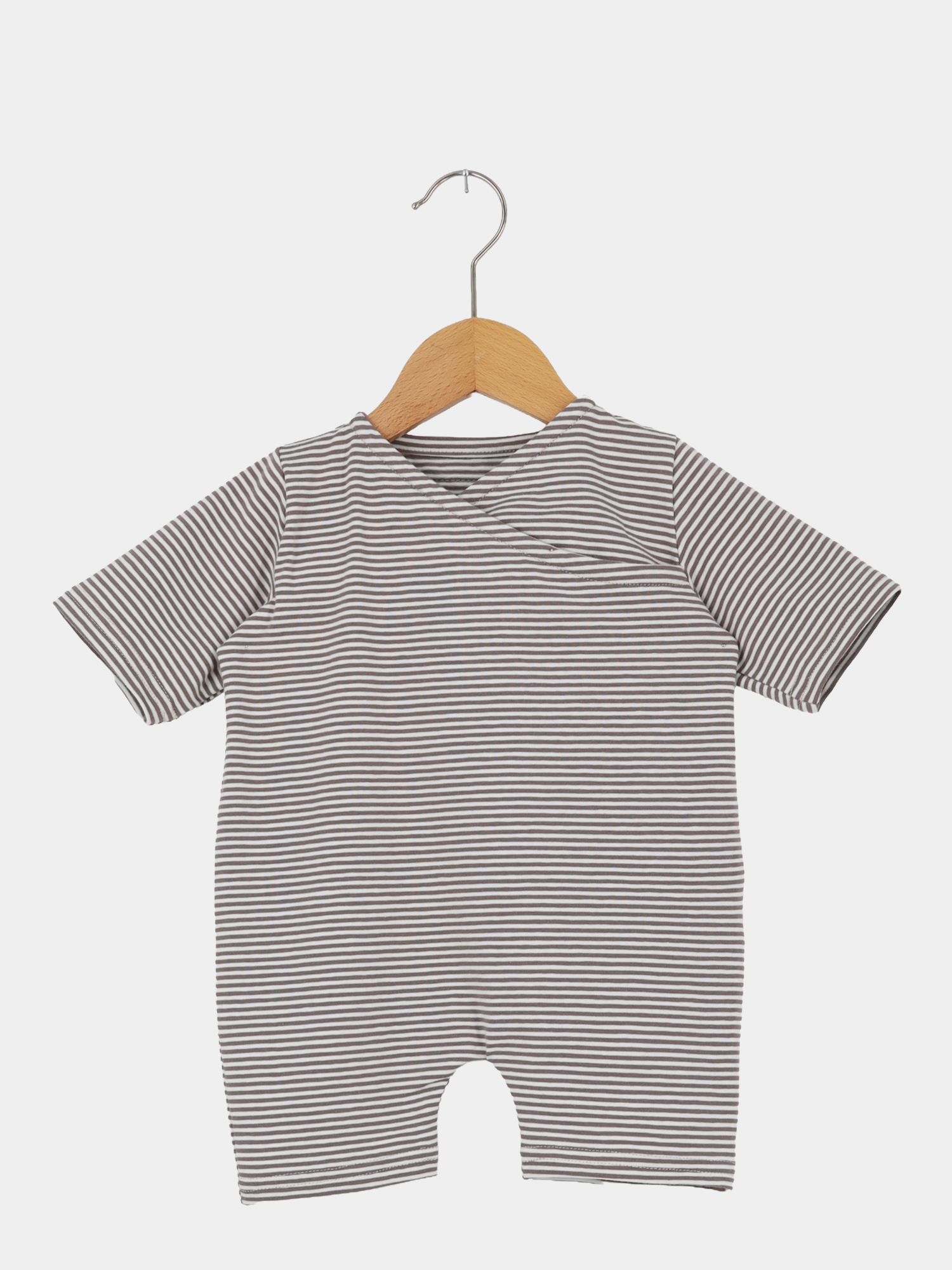Wickel Overall Baumwolle - Ringel Praline: Kurzärmeliger Baby-Body mit schmalen grauen und weißen Streifen, aus weichem Baumwoll-Jersey, hängt an einem Holzkleiderbügel vor weißem Hintergrund.